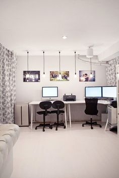 two computer desks sitting in front of computers on top of a white countertop