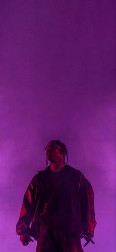 a man standing in front of a purple background