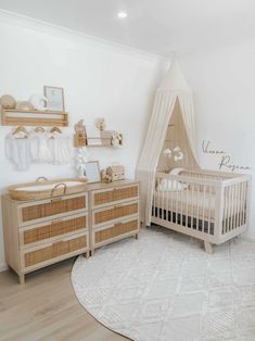 a baby's room with a crib, dressers and other furniture in it