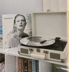 a record player sitting on top of a book shelf