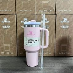 the pink tumbler is next to some boxes