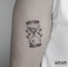 an hourglass tattoo on the left arm