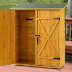 an outdoor wooden storage shed with sliding doors