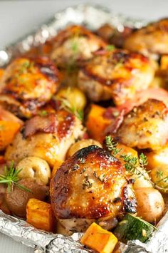 chicken, potatoes and carrots in a foil pan