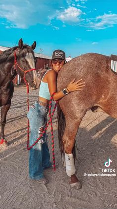 a woman standing next to a brown horse