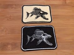 two black and white patches with fish on them