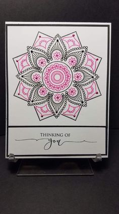 a card with the words thinking of joy written in black and pink ink on it