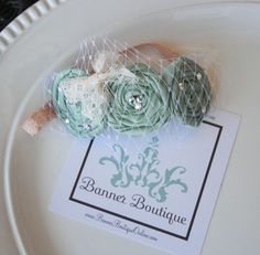 a white plate topped with green flowers on top of a table next to a label