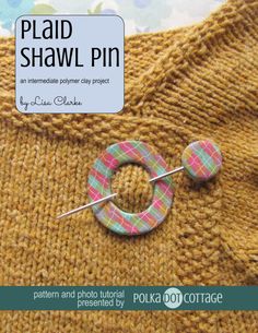 a knitted sweater with a pin in the middle and an image of a button on it