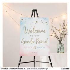 a welcome sign sitting on top of a easel next to a vase filled with flowers