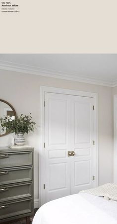 a white bed sitting next to a dresser in a bedroom