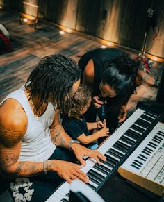 a group of people that are sitting around a keyboard