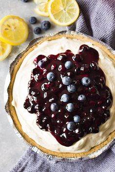 a pie topped with blueberries and lemon slices