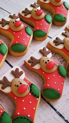 decorated christmas cookies are arranged on a table