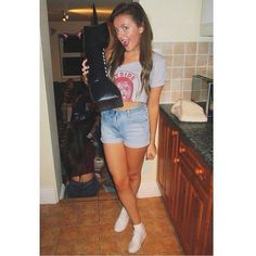 a woman standing in a kitchen with her leg up