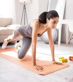 a woman is doing push ups on a yoga mat with fruits and vegetables in the background