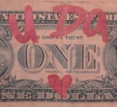 an old one dollar bill with pink writing on it