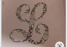 an image of a drawing on paper with flowers and circles in the shape of letters