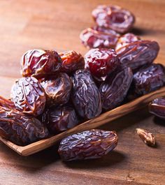 dried raisins in a wooden spoon on a table