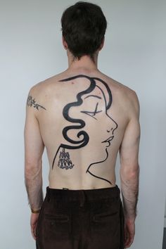 a man with a tattoo on his back