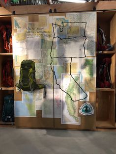 a map is on display in a storage area with backpacks and other items around it