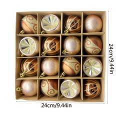 twelve ornaments in a cardboard box are shown