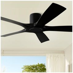 a black ceiling fan in a white room