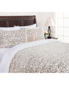 a leopard print comforter set on a bed