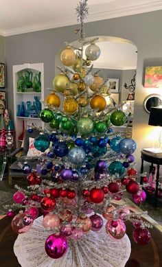 a christmas tree made out of ornaments in a living room