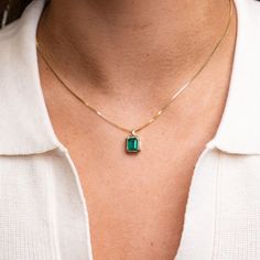 Our 14k Emerald Bezel Necklace features a lustrous and stunning genuine emerald forged in 14k yellow gold. We love the enhanced statement that this setting makes with its thick layer of gold perfectly bordering the natural emerald cut stone. 14k Solid Gold and Genuine Emerald Approximately 1.5 CTW Available as a pendant only, or with our 14k Cable Chain or Box Chain Available in lengths 16", 18", and 20" Due to the handmade nature of this necklace, please allow 1 - 3 weeks for processing. Yellow Gold Necklace With Emerald Cut Bezel Setting, Yellow Gold Emerald Cut Necklace With Bezel Setting, Yellow Gold Emerald-cut Necklace With Bezel Setting, 14k Gold Jewelry With Bezel Set Rectangular Stone, Rectangular Emerald Jewelry With Bezel Setting, Classic Yellow Gold Emerald Cut Necklace, Luxury Radiant Cut May Birthstone Jewelry, Yellow Gold Emerald Jewelry With Rectangular Stone, Gold Emerald-cut Jewelry With Bezel Setting