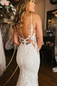 a woman in a wedding dress looking back