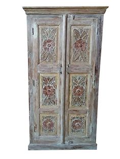 an old wooden armoire with carved flowers on the front and side panels, painted in white