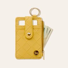 a yellow wallet with money in it and a keychain hanging from the front