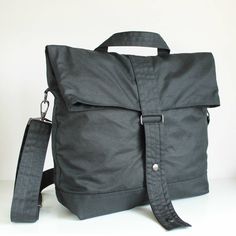 "Black Multi Way Waxed Canvas Backpack MATERIALS Exterior fabric: 100% black waxed cotton canvas (British) Lining fabric: 100% cotton twill (Italian) APPROXIMATE DIMENSIONS Width: 35cm / 13.75\" Depth: 12.5cm / 5\" Height: 38cm / 15\" Shoulder strap length: adjustable from 96.5cm to 175cm / 38\" to 69\" Exterior zipper pocket at back: 26cm / 10.25\" W x 25cm /10\" H Interior sleeve pocket 1: 9cm /3.5\" W x 15cm / 6\" H x 2cm / 0.75\" D Interior sleeve pocket 2: 9.5cm /3.75\" W x 15cm / 6\" H x 2 Black Canvas Tote Backpack, Black Waxed Canvas Backpack For Everyday Use, Everyday Black Waxed Canvas Backpack, Black Waxed Canvas Standard Backpack, Black Waxed Canvas Backpack, Functional School Bag With Waxed Finish, Black Waxed Finish Backpack, Black Waxed School Bag, Waxed Canvas Backpack