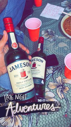 two bottles of jameson are sitting on a table with cups and sauces in front of them