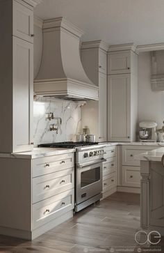 a large kitchen with white cabinets and marble counter tops on the island in front of an oven