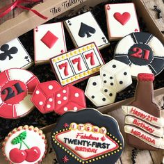 decorated cookies in a box with casino themed decorations on them and the words happy twenty - first birthday