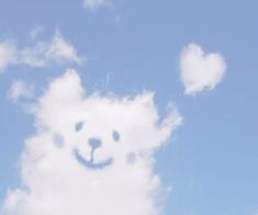 there is a bear made out of clouds in the sky with a smile on it's face