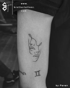 a black and white photo of a person's arm with a tattoo on it