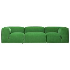 a green couch sitting on top of a white floor