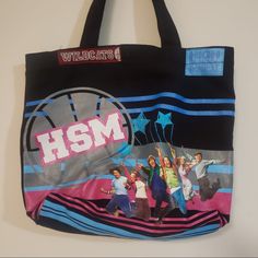 a black tote bag with the words hsm on it and images of young people