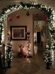 an archway decorated with christmas decorations and lights