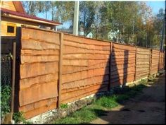 a wooden fence that is next to a house