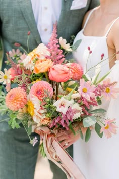 the bride and groom are holding their bouquets