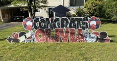 a graduation sign in front of a house that says congrats on the lawn