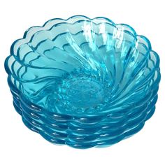 a blue glass bowl sitting on top of a white table