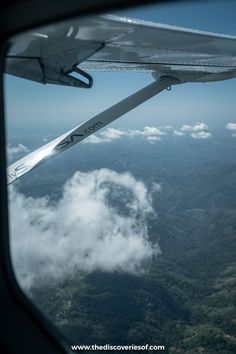 the wing of an airplane flying over some clouds