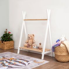 a teddy bear sitting on a wooden swing in a child's playroom with toys