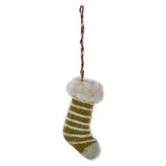 a christmas stocking hanging from a red and white striped ribbon on a white background