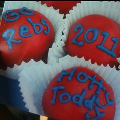 four red cupcakes with blue frosting that say 2013 and the words hotty toddy written on them